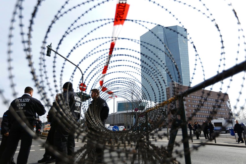 German police officers stand behind barbed wire beside the European Central Bank (ECB) in Frankfurt