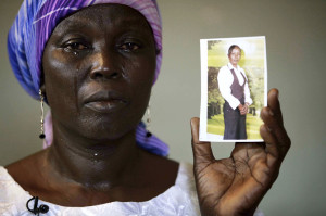 Martha Mark, the mother of one of the kidnapped school girls cries as she displays her photo, in the family house, in Chibok, Nigeria, May 19, 2014.