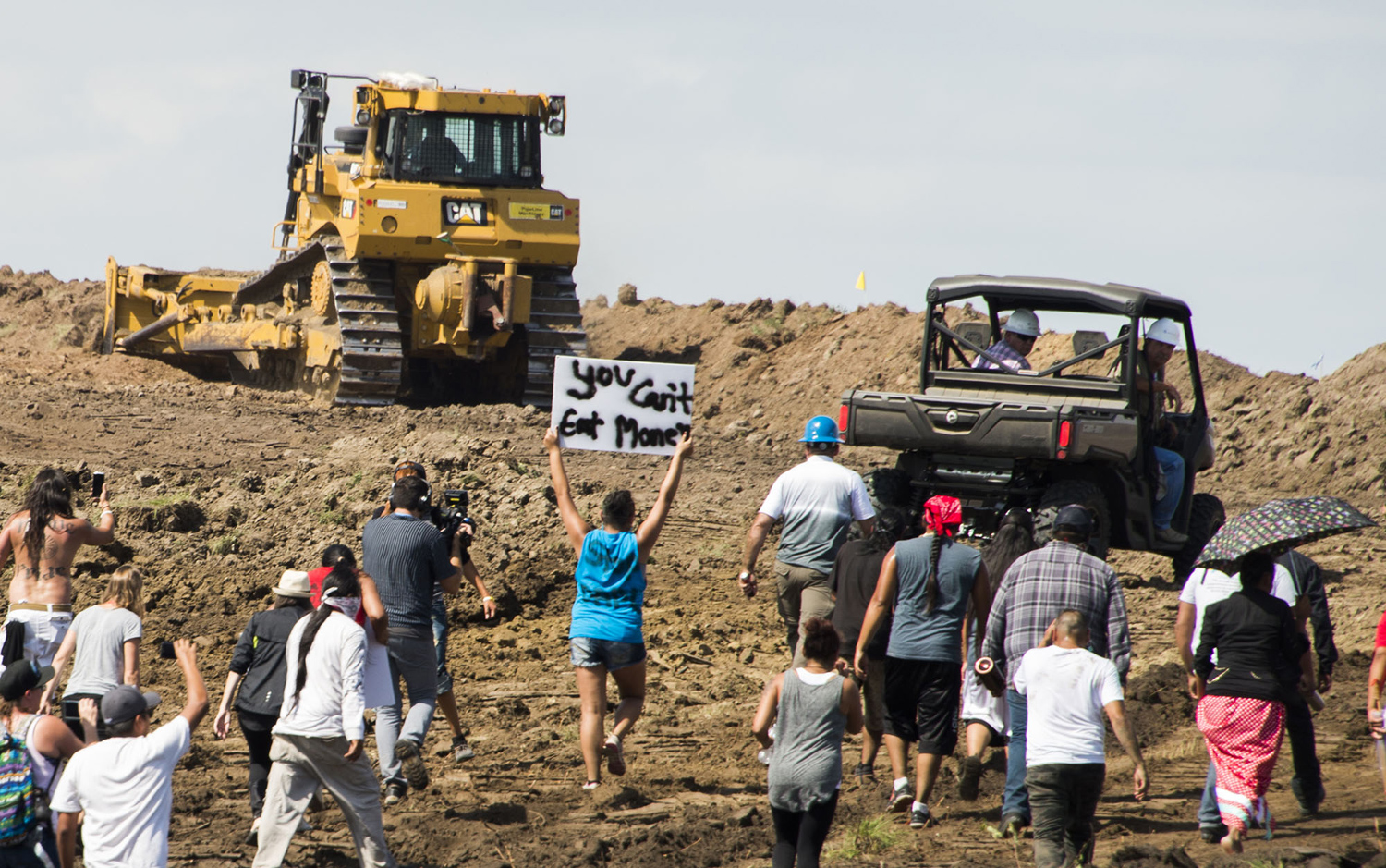 Native American protestors and their supporters are confronted by security during a demonstration against work being done for the Dakota Access Pipeline (DAPL) oil pipeline, near Cannon Ball, North Dakota, September 3, 2016. Hundreds of Native American protestors and their supporters, who fear the Dakota Access Pipeline will polluted their water, forced construction workers and security forces to retreat and work to stop. / AFP / Robyn BECK        (Photo credit should read ROBYN BECK/AFP/Getty Images)